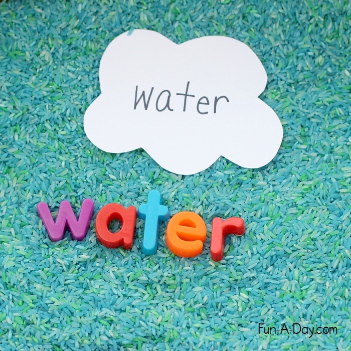 Making words with magnetic letters in an Earth Day sensory bin