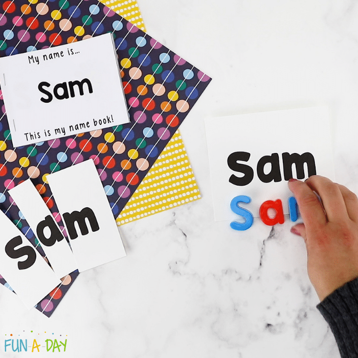 spelling out the name 'sam' in magnetic letters next to the pieces of a preschool name kit