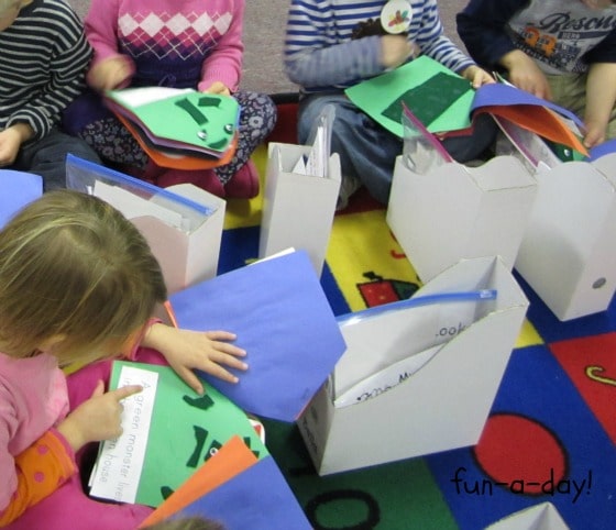 children reading homemade books in preschool classroom