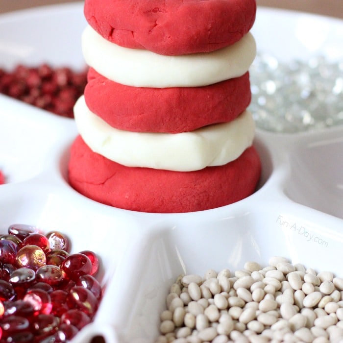 Close up of red and white play dough with red and white loose parts