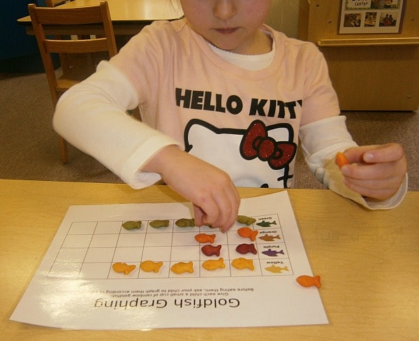 Preschooler counting goldfish crackers on a graph