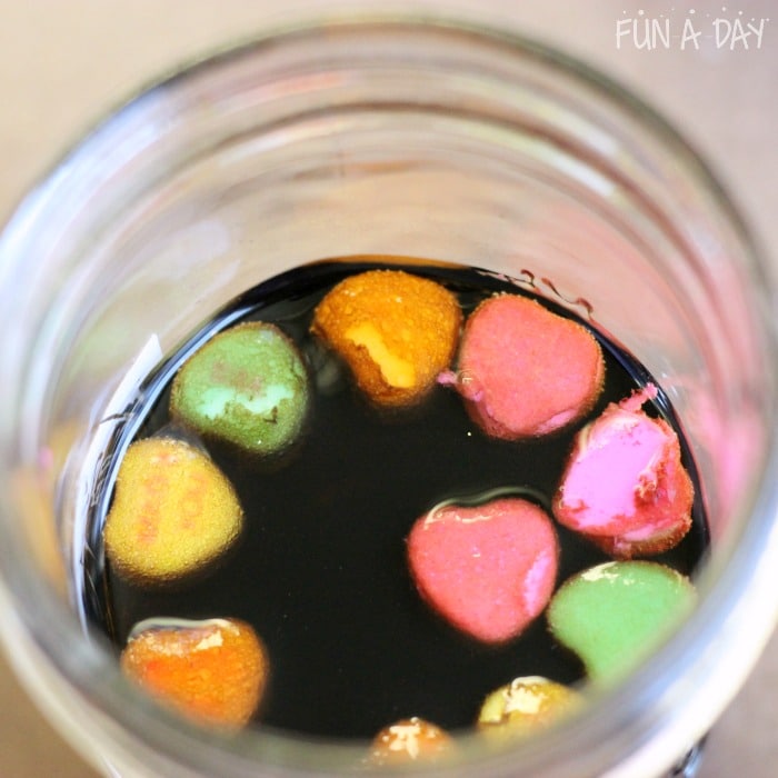 Candy hearts dissolving in soda