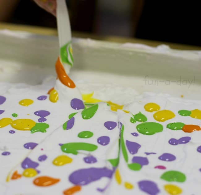mixing up a colorful design for shaving cream art