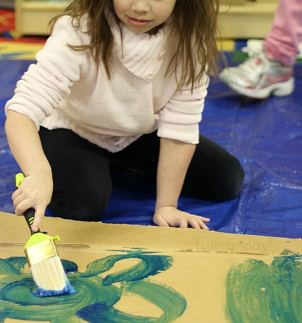 Recycled Art Projects for Kids - painting the walls of our giant cardboard castle