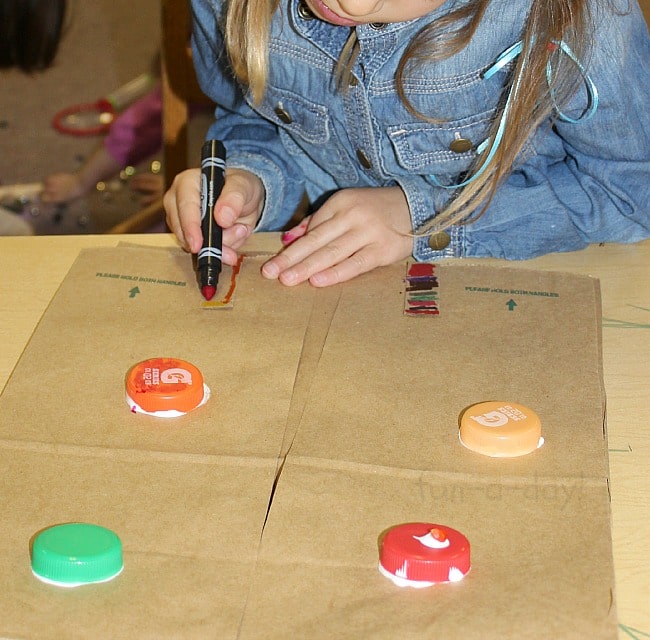 Drawing on her robot vest - Easy Robot Craft Made from Recycled Materials