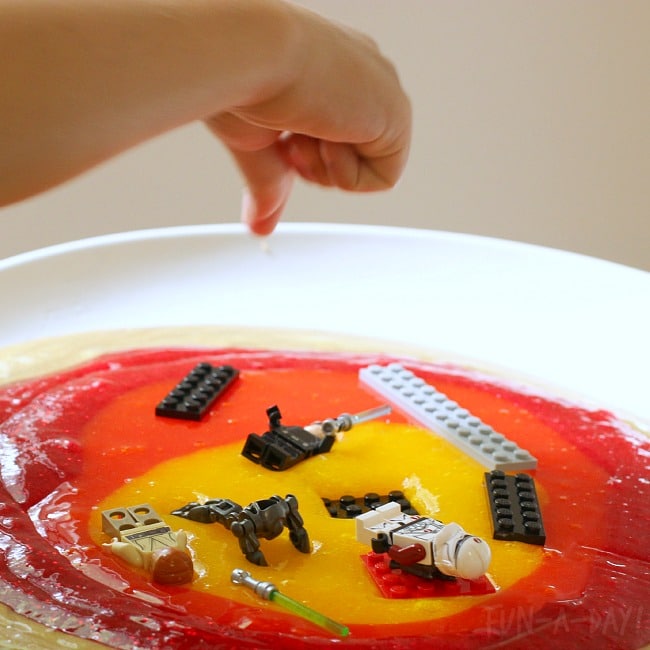 child pretend play with Lego Star Wars minifigures and bricks in lava slime