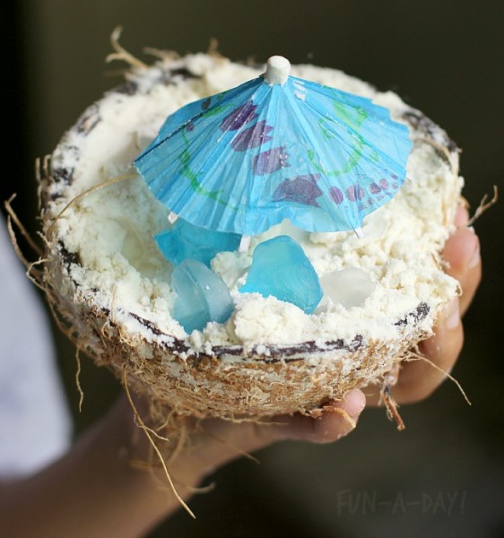 coconut cloud dough with sea glass, tiny umbrellas, and coconut shells