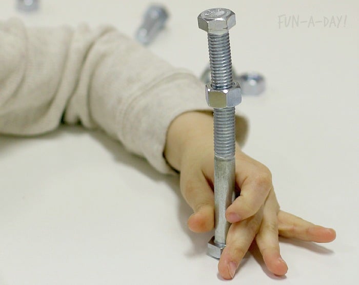 connecting nuts and bolts during a fine motor activity