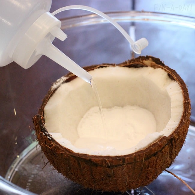 getting ready to make the coconut erupt with this baking soda and vinegar experiment
