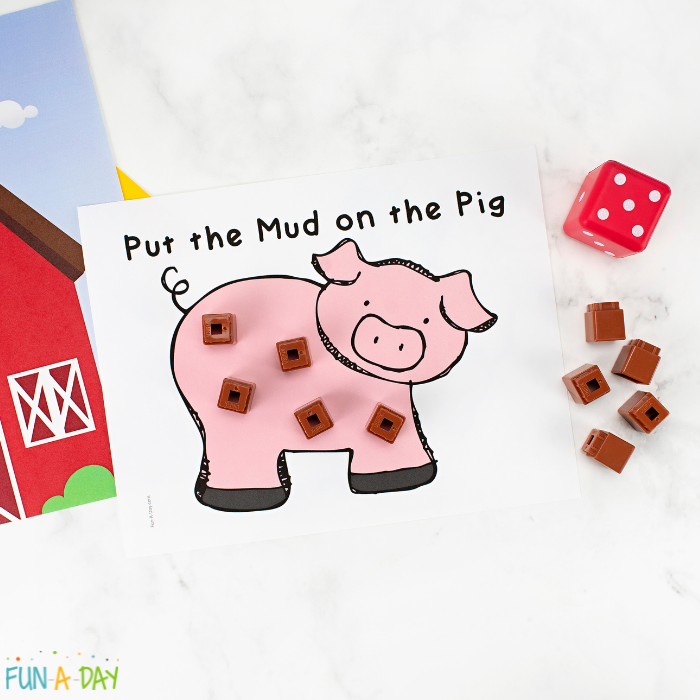 one of our favorite farm math games a printable dice game for a farm theme next to a die and brown cubes