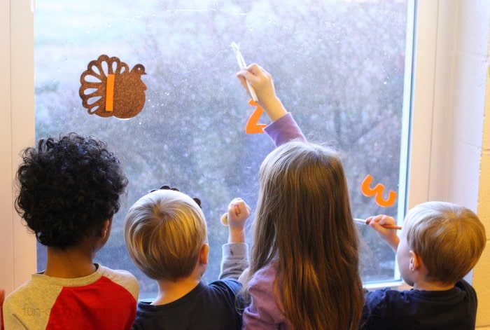 Preschoolers enamored with a simple Thanksgiving math activity