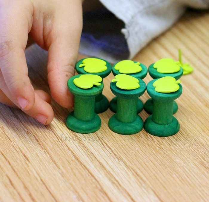 color matching game with green spools and green apple brads