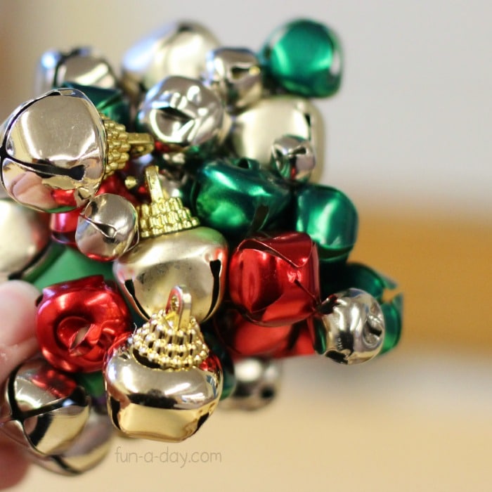 Loading up magnets with jingle bells with a preschool magnet science activity