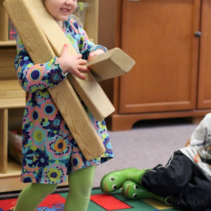 Showing off how many blocks she can carry! Look at that smile - she's so proud!