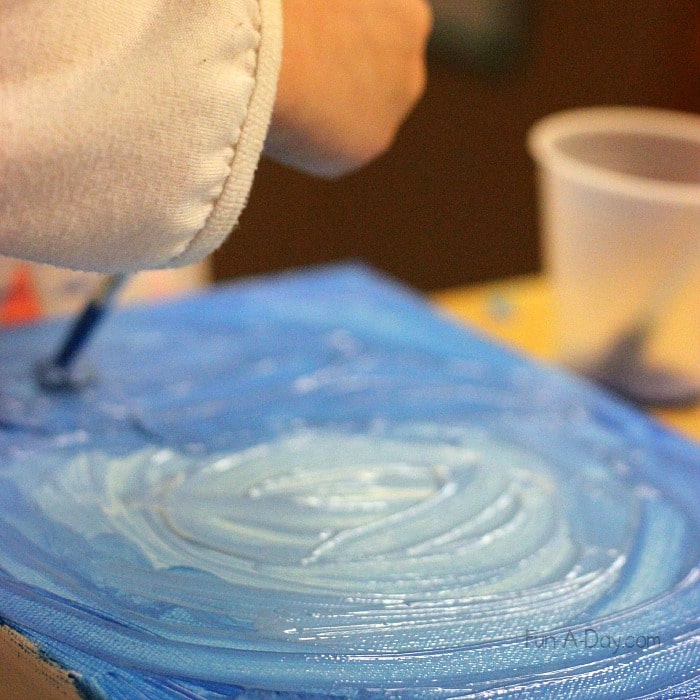 Art for preschoolers - painting a blue sky as part of our daynight canvas project