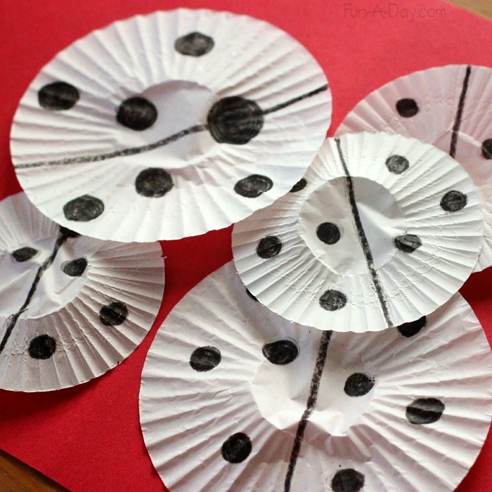 Cupcake liner ladybug craft for kids - getting ready to paint