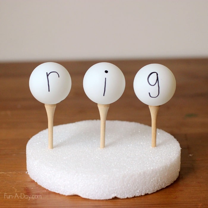 Use ping pong balls and golf tees for a fine motor literacy activity teaching word families