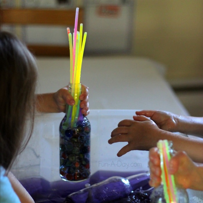 This space activity is super fun with the lights switched off so the kids can see the glowsticks - Glowing Galaxy Water Play