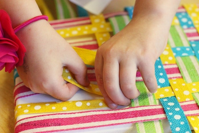 Little fingers get some fine motor work outs with this weaving art project