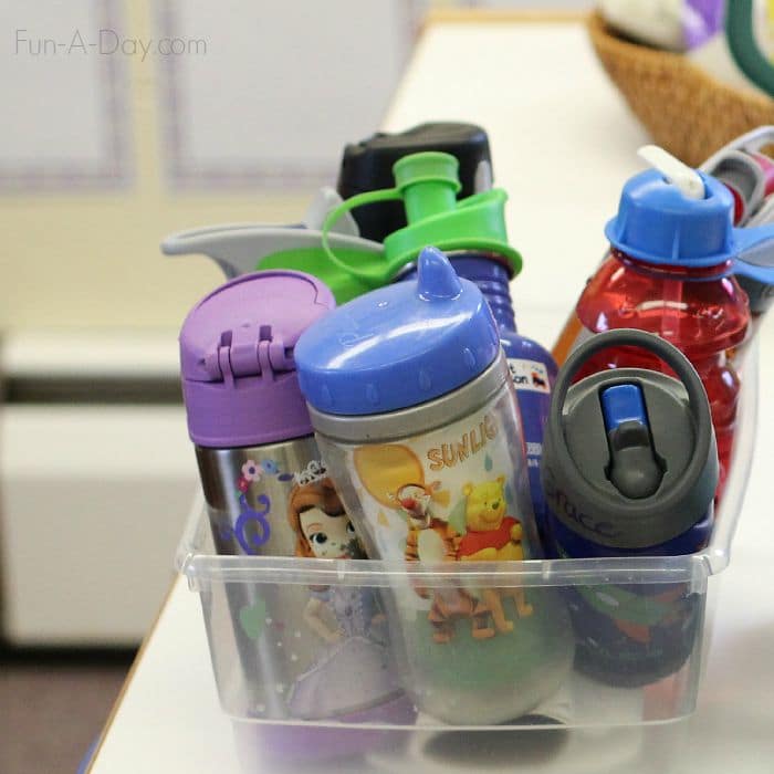 Putting drink cups away is part of the preschool morning routine - includes free printable morning routine chart
