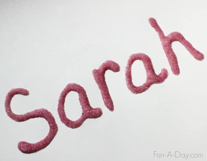 the name 'Sarah' written in glue and covered with purple jell-o powder