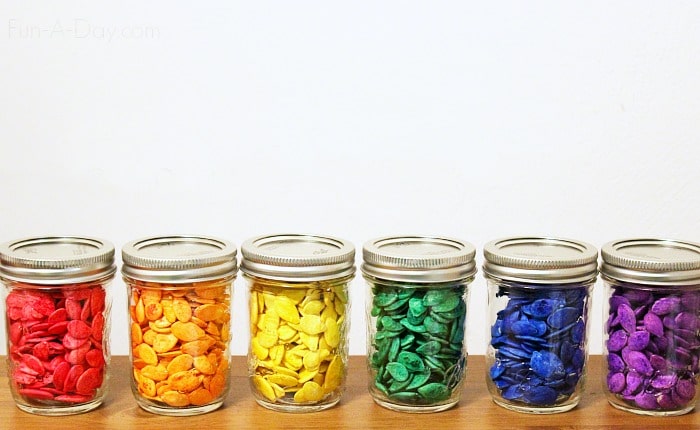 jars of dyed pumpkin seeds