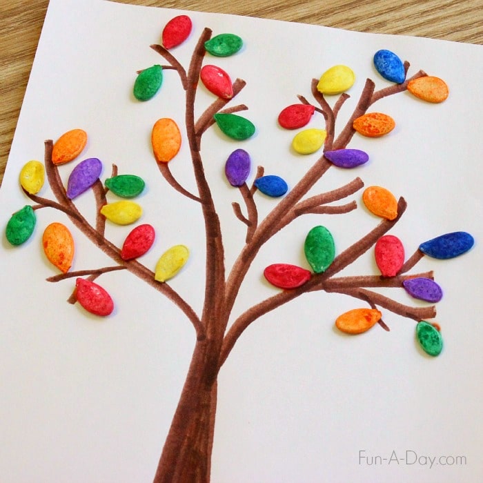 hand drawn fall tree with dyed pumpkin seeds as leaves