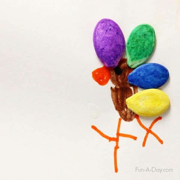 Child drawn turkey with dyed pumpkin seeds as feathers.