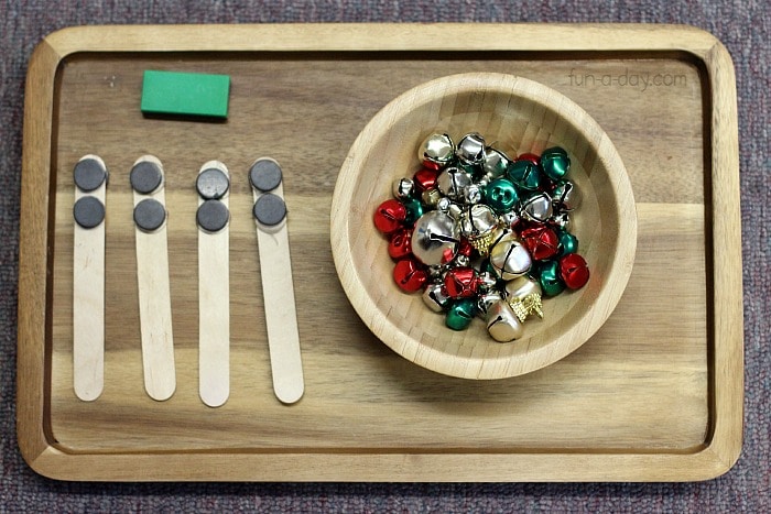 Wooden tray with magnets and a wooden bowl containing jingle bells