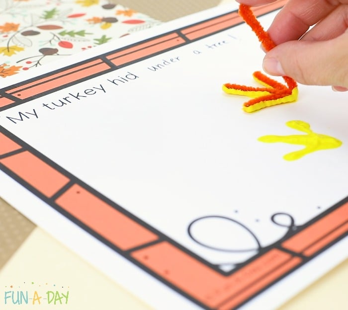 Stamping turkey tracks on free printable class book about turkey art