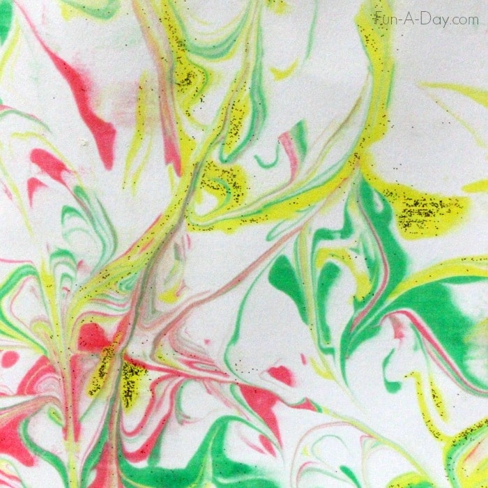 a red, green, and yellow marbled pattern on a homemade christmas card