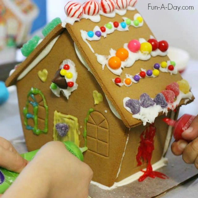 Decorating a gingerbread house together - love how it took an unconventional turn after this