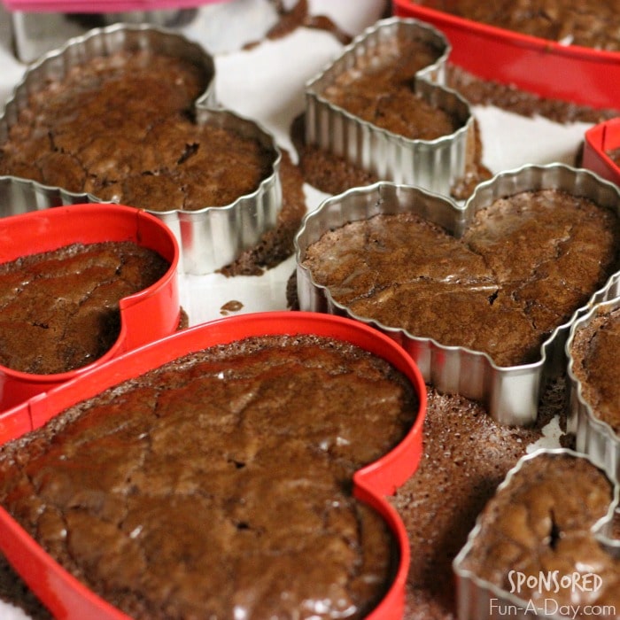 cooked brownies in heart-shaped metal cookie cutters