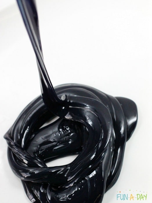 A swirl of black slime pooling on a table.