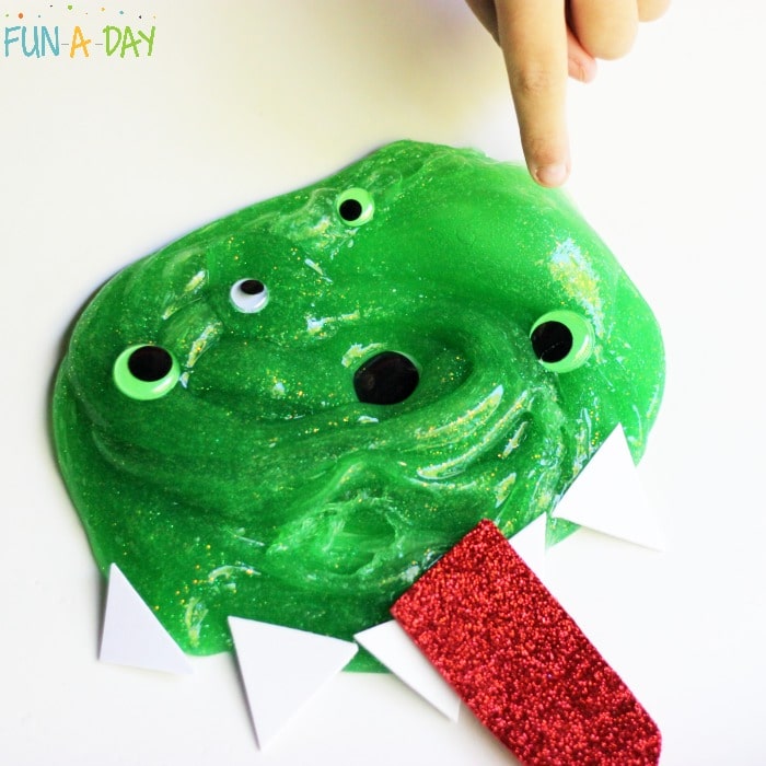 green slime turned into a monster with googly eyes, white foam triangle teeth, and red foam tongue