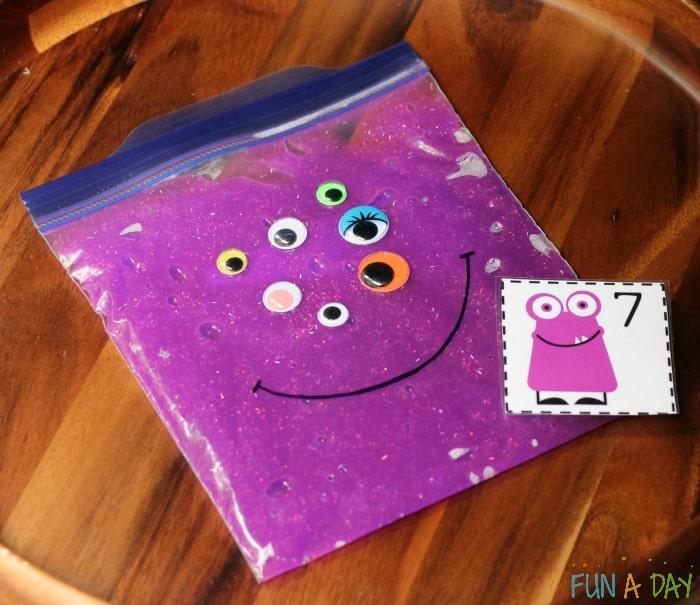 Fall math activities for preschoolers using purple slime in a baggie, googly eyes, and printable number cards.