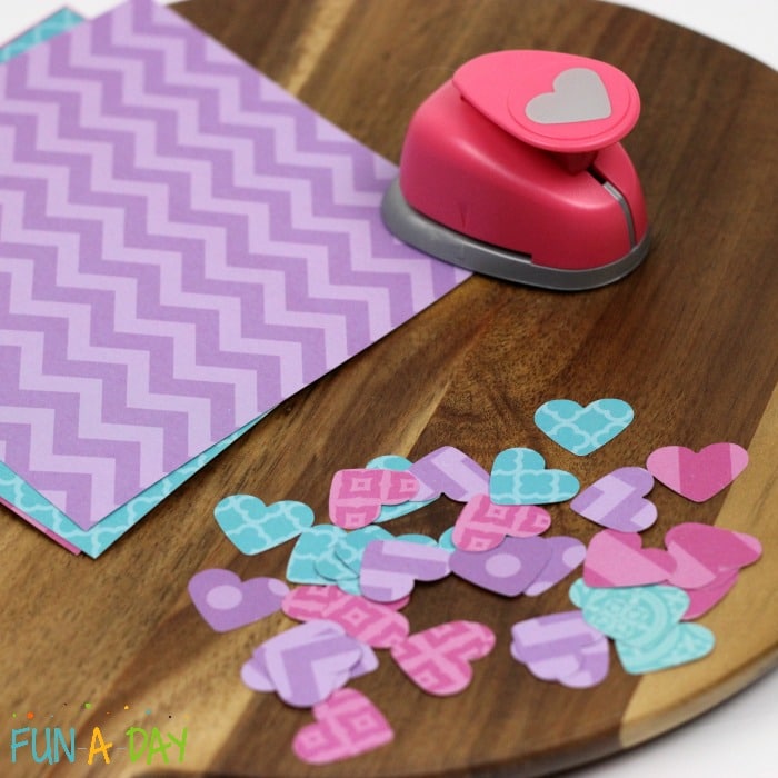 small paper hearts that have been made with a heart hole punch and scrapbook paper 