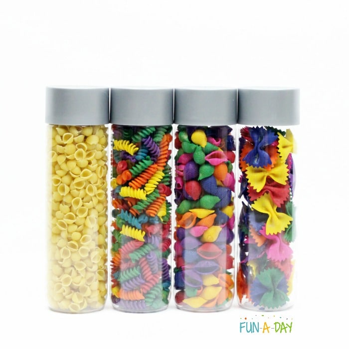Sensory bottles for preschool butterfly theme filled with colorful pasta shapes