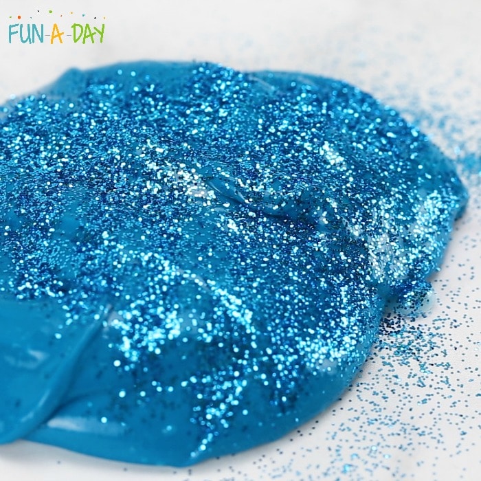 Adding glitter to teal slime