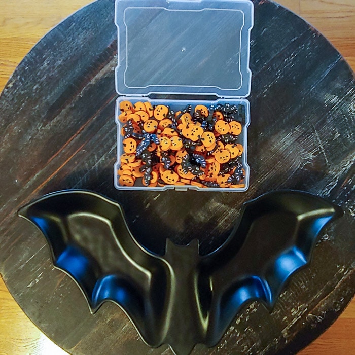 black bat serving dish with jack o'lantern and bat mini erasers to sort in preschool