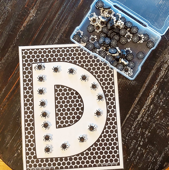 Letter D printable page with spider mini erasers forming the letter