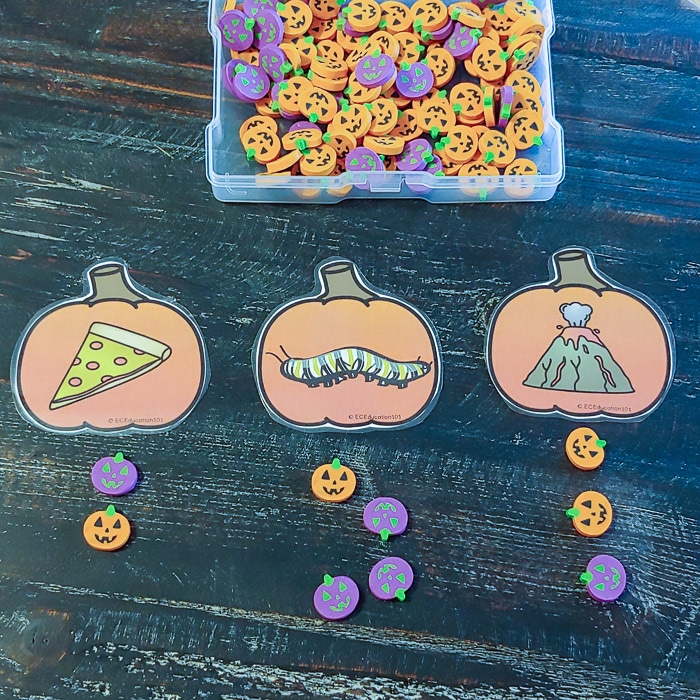 Printable pumpkin syllable cards with small Halloween erasers.