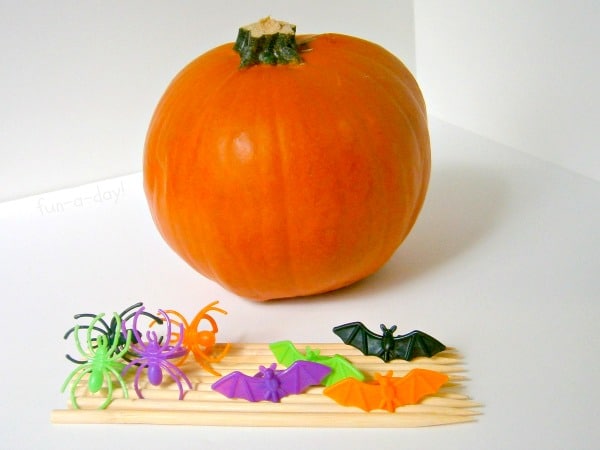 pumpkin, bamboo skewers and spider rings to make pumpkin craft