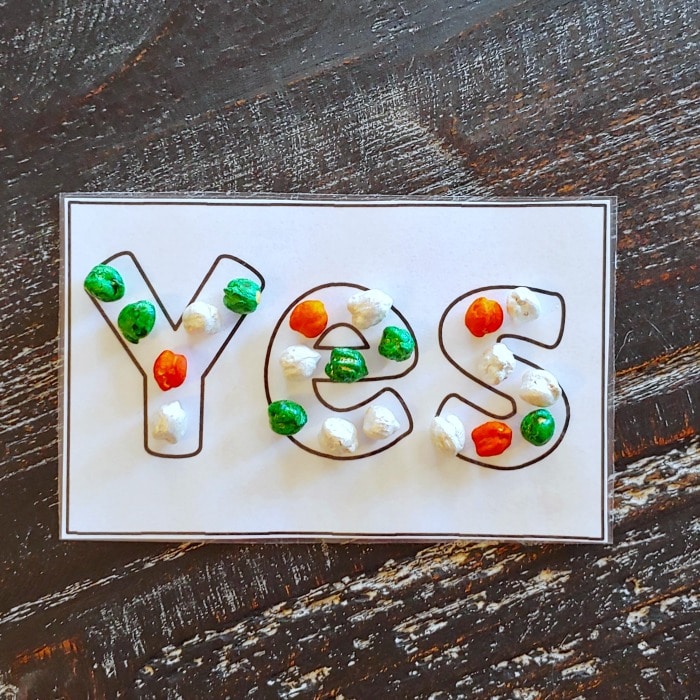printable of the word yes with dyed chickpeas forming the letters