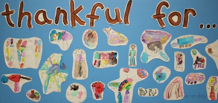 Thanksgiving bulletin board filled with kids' drawings and text that reads thankful for