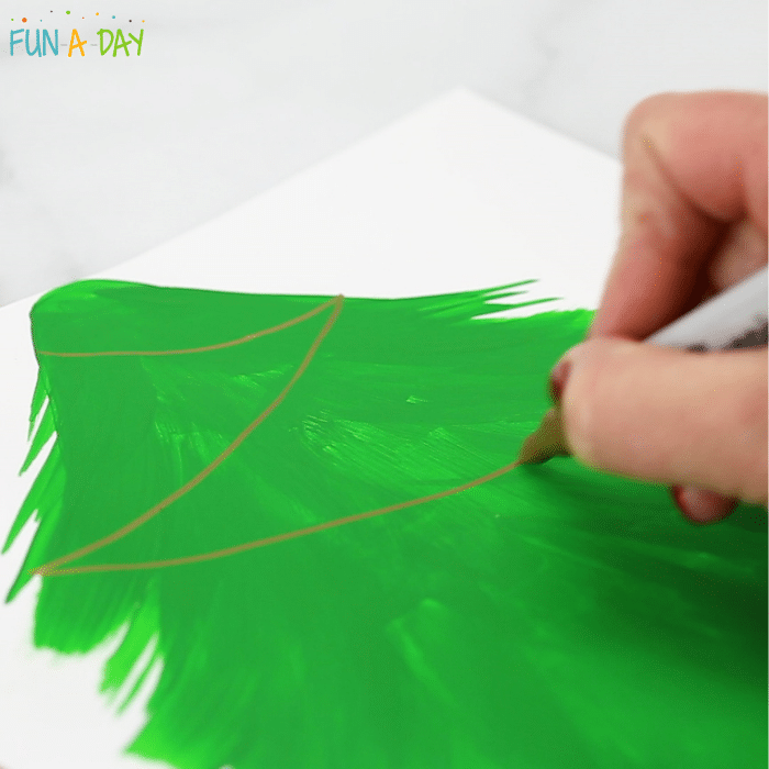 painted evergreen tree with hand drawing light strands with metallic marker