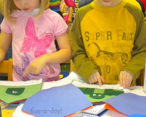 two children reading a monster book