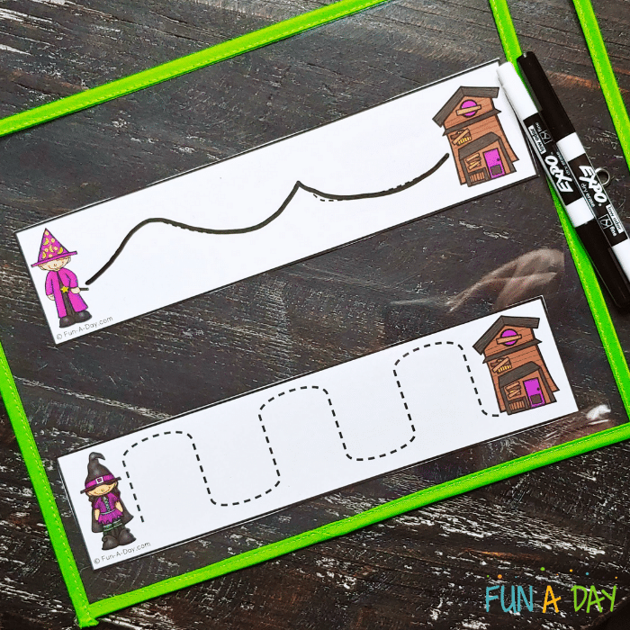 Two Halloween tracing strips in a dry erase pocket with 2 dry erase markers.
