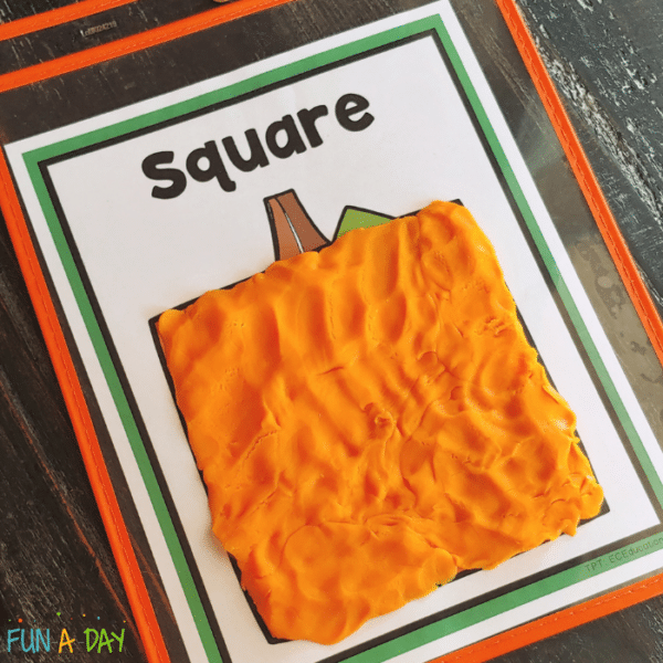 Printable pumpkin shape mat with a square pumpkin covered in orange play dough.