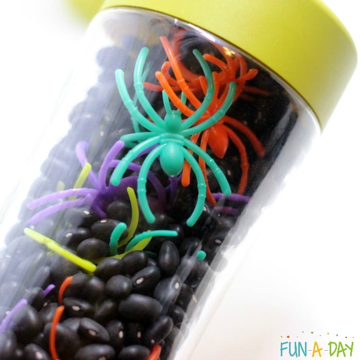 jar with black beans and spider rings